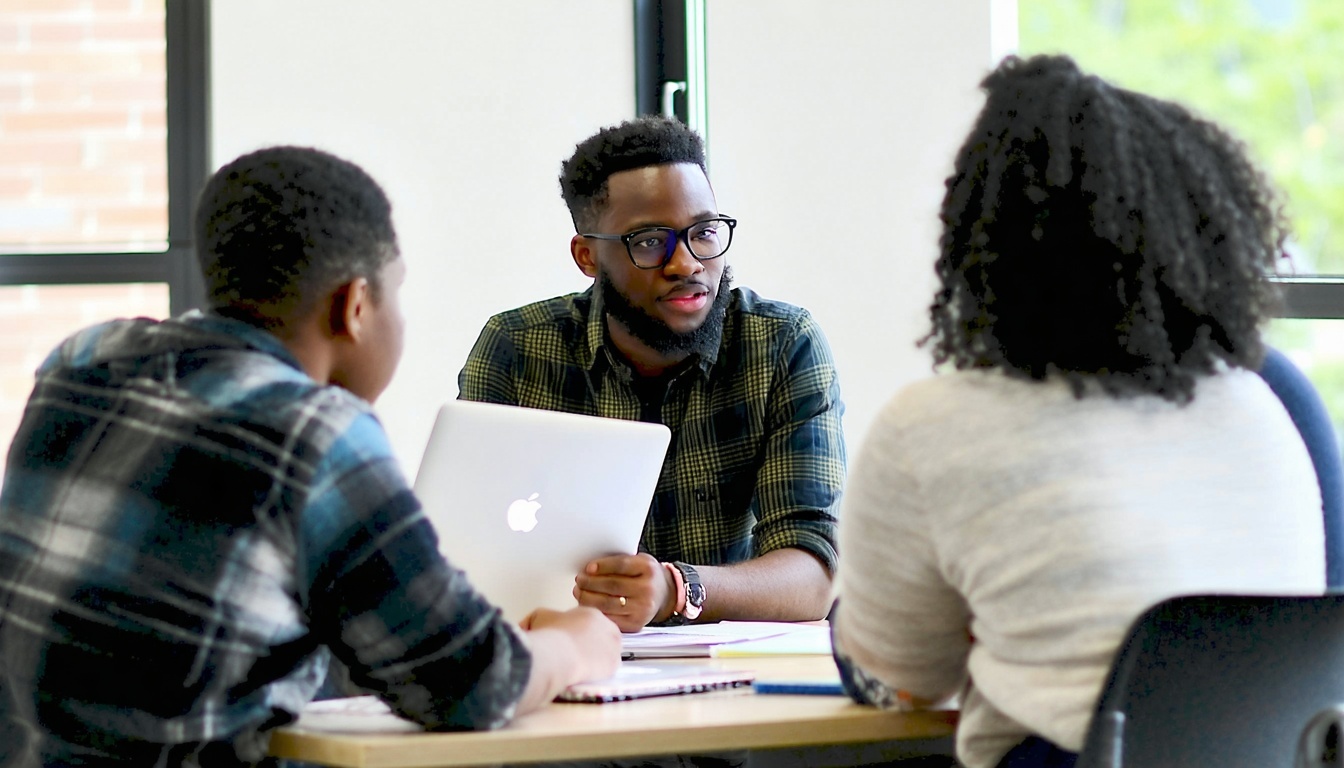 Supportive trainers assisting learners during a workshop